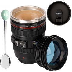 a camera lens cup with a spoon next to it and the lid open, on a white background