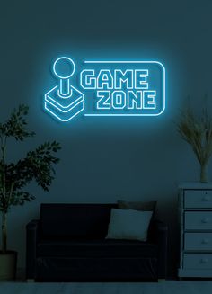 a neon sign that says game zone next to a couch in a room with a potted plant