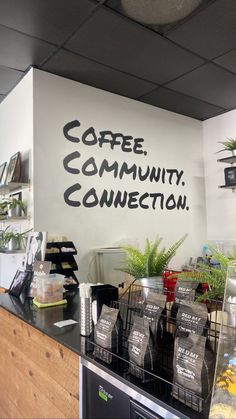 the coffee community connection sign is painted on the wall above the counter in this coffee shop