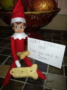 an elf is holding a sign that says most cookies ever don't give these to santa