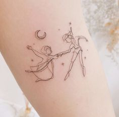 a tattoo on the leg of a woman holding hands with a man who is standing next to her