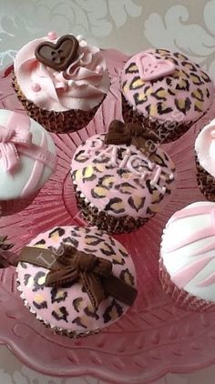 cupcakes decorated with pink and brown decorations