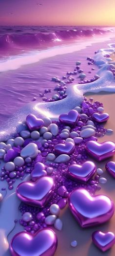 purple hearts floating in the water on a beach