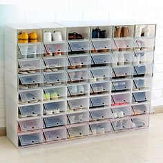 a white shelf filled with lots of clear bins