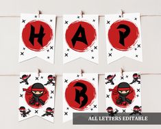 some red and black letters are hanging from clothes pins with ninjas on them to spell out the word happy