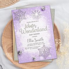 a baby shower with snowflakes on the front and sides, sitting on top of a wooden plate