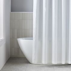 a white bath tub sitting next to a window