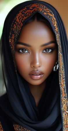 an african woman with blue eyes wearing a black shawl