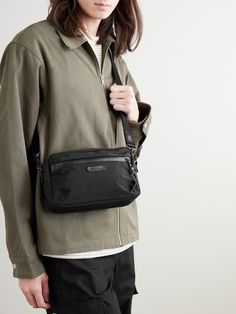 So much thought goes into the materials that make Master-Piece's bags – the front pocket of this 'Root S' messenger, for example, has a water-repellent AquaGuard® zip. Made from hard-wearing nylon with leather trims, it has an adjustable shoulder strap and is sized to hold your phone, keys and wallet. Nylon Shoulder Bag With Pockets For Commuting, Nylon Shoulder Bag With Functional Pockets For Commuting, Commuting Crossbody Bags With Pockets, Modern Nylon Shoulder Bag With Multiple Pockets, Modern Shoulder Bag With Functional Pockets For Everyday, Everyday Shoulder Bag With Pockets, Nylon Crossbody Bag For Everyday Carry, Nylon Bags With Pockets For Everyday Carry, Nylon Shoulder Bag For Everyday Use