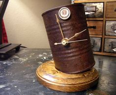 a clock made out of an old barrel sitting on top of a table