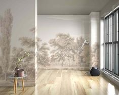 an empty room with a wallpapered mural and wooden flooring in front of a window