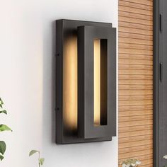 a modern outdoor wall light mounted on the side of a building with wood slats