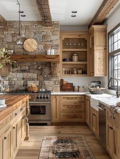 a kitchen filled with lots of wooden cabinets and counter top space next to a window