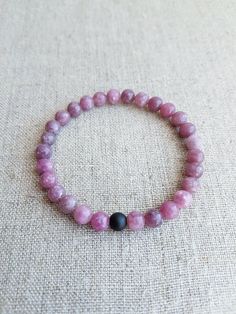 "READY TO SHIP. Lepidolite Gemstone Bracelet*Beaded Bracelets*Stretch Bracelet*Gemstone Jewelry*Gemstone Bracelets for Women*Pink Bracelet*Bead bracelet. Beautiful natural Lepidolite gemstone bracelet will make you look gorgeous. Lepidolite bracelet is the perfect addition to women's or girl's jewelry. Material: Natural Lepidolite gemstone, stretch cord, Matte Black Onyx gemstone Color: Pink Bracelet size: Approx. 16 cm / 6.3\" in (The size could be adjusted upon request) Beads size: Approx. 6 mm / 0.24\" in Please note that color might slightly differ to photography.  For more natural gemstone bracelets, visit my shop: https://www.etsy.com/shop/LemonBracelet Thank you for shopping at LemonBracelet!" Pink Gemstone Beads Bracelets For Meditation, Pink Stretch Bracelet With Natural Stones For Meditation, Pink Natural Stones Stretch Bracelet For Meditation, Pink Gemstone Beaded Bracelets For Healing, Rhodonite Natural Stone Bracelets As A Gift, Pink Spiritual Gemstone Beaded Bracelets, Spiritual Pink Gemstone Beaded Bracelets, Lepidolite Bracelet, Pink Beaded Bracelets