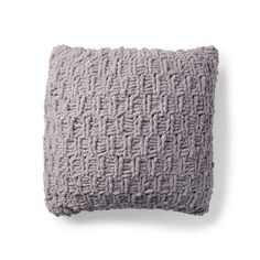 a gray pillow on a white background with the words, knitted in small squares