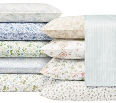 a stack of sheets and pillow cases with flowers on them