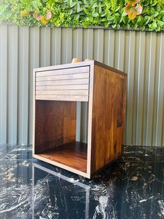 a wooden box sitting on top of a black table