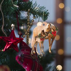 two dogs are standing on top of each other ornament hanging from a christmas tree