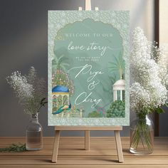 a welcome sign with flowers in vases next to it on a wooden easel