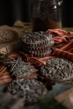 some cookies are sitting on a table next to a jar