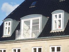 three windows on the roof of a building