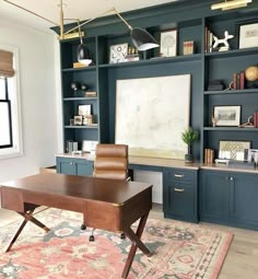 a home office with built in bookcases and desk