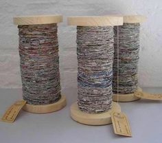 three spools of thread sitting next to each other on top of wooden stands