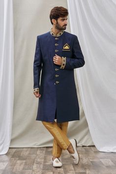 Navy blue asymmetric sherwani with embroidered mandarin collar. Paired with pant.
Component: 2
Pattern: Embroidered
Neckline: Mandarin
Sleeve Type: Full Sleeves
Fabric: Art Banarasi Silk, Dupion Art Silk
Color: Blue
Other Details: 
Front buttons
Note: Pocket square worn by the model is not for sale
Occasion: Sangeet - Aza Fashions Embroidered Neckline, Fashion App, Full Sleeves, Blue Art, Embroidered Silk, Fabric Art, Mandarin Collar, Pocket Square, Aza Fashion