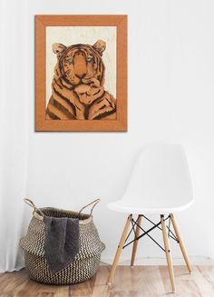 a tiger painting is hanging on the wall next to a white chair and wooden basket