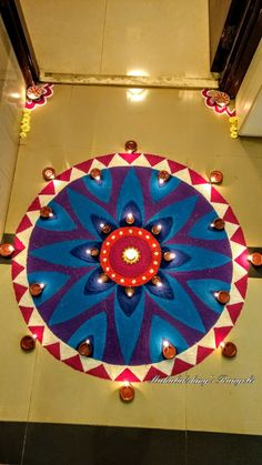 an overhead view of a colorfully decorated floor with candles on the bottom and in the middle