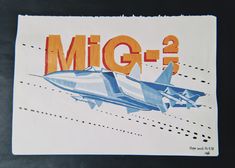 an airplane with the word'mid - g - 2'written in orange and blue