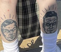 two people with tattoos on their legs and one has a face tattooed on the leg