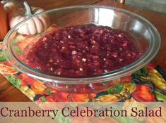 cranberry celebration salad in a glass bowl on a placemat with pumpkins