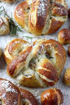 some bread rolls with cheese and herbs on top