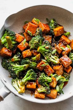 broccoli and tofu in a bowl with sesame seeds