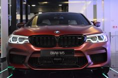 the front end of a red bmw m5