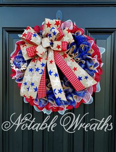 a red, white and blue wreath is hanging on a door with the words patriotic wreaths