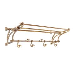 an antique brass coat rack with four hooks