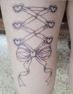 a woman's thigh with hearts and bows on it