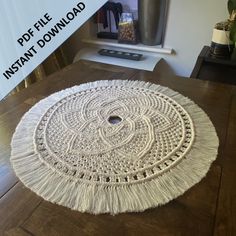 a round rug with fringes on the floor next to a coffee table and vase