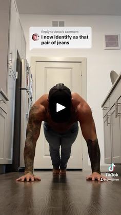 a man is doing push ups on the floor in front of an open door with his head down