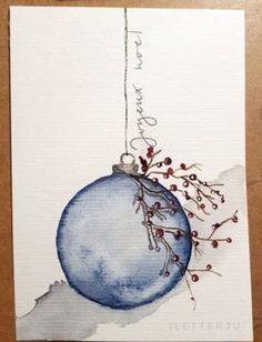 a watercolor painting of a blue christmas ornament