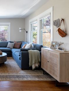 a living room filled with furniture and windows