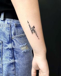 a woman with a small tattoo on her arm