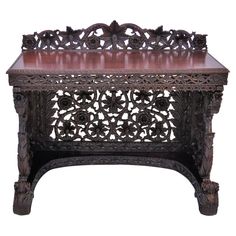 an ornate wooden table with carvings on it