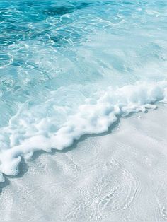 an ocean wave is coming in to the shore and it looks like foamy water