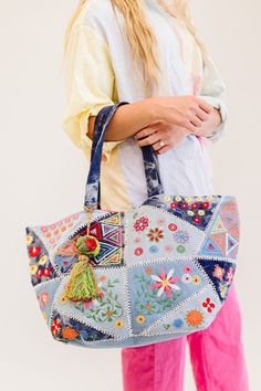 This one goes out to all our boho babes! The Arden is a colorful oversized tote that's sure to brighten up your day. This handmade piece features so many unique details, from the patchwork and tie-dye denim design to the bright fuchsia interior (no more digging in the endless abyss to find your keys). The Arden pairs well with all of your favorite summer activities: farmer's markets, getaways, beach time, and more! Details: 20” long x 14" height x 11” wide 3 interior pockets Patchwork denim deta Bohemian Patchwork Bags For Summer, Denim Tote Bag For Summer, Bohemian Rectangular Bag For Spring, Bohemian Spring Tote Bag, Summer Patchwork Bags For Daily Use, Summer Multicolor Patchwork Bag, Bohemian Bags For Everyday Use In Spring, Summer Patchwork Tote Bag, Summer Patchwork Bags For Everyday Use