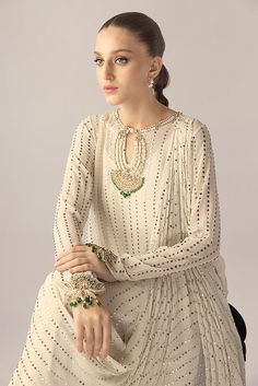 An ivory georgette long shirt with a draped dupatta is handworked with delicate kamdani. The sleeves and neckline are detailed with jewelled floral motifs. An elegant ensemble for any formal event or soiree. Sania Maskatiya, Ladies Suits, Indian Inspired, Asian Outfits, Dress Sewing Patterns, Dress Sewing, How To Dye Fabric, Indian Designer Wear, Shirt And Pants