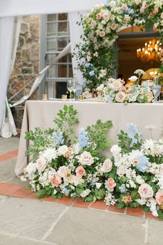 a table with flowers and greenery on it