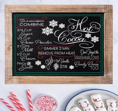 a chalk board with christmas treats on it and candy canes in front of it